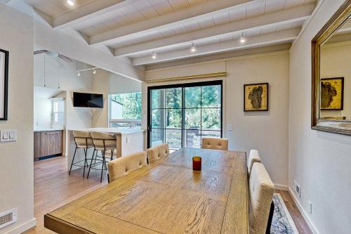 a dining room and kitchen with a wooden table and chairs at Modern Mountain Getaway in Olympic Valley