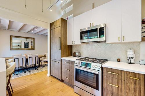 a kitchen with white cabinets and a stove top oven at Modern Mountain Getaway in Olympic Valley