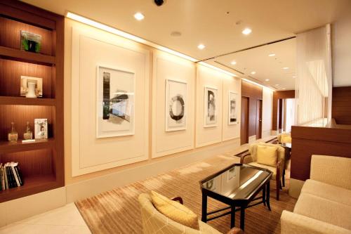 a living room with a couch and a table and chairs at Hotel Kitano Plaza Rokkoso in Kobe