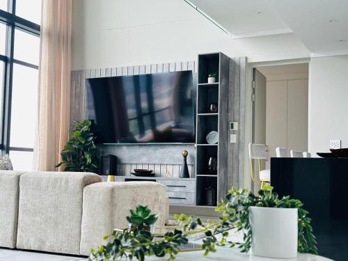 a living room with a couch and a tv at Masingita Towers Hotel and SPA in Johannesburg