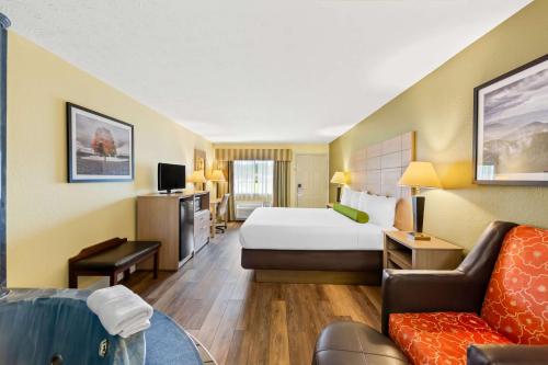 a hotel room with a bed and a couch at Best Western Dayton in Dayton