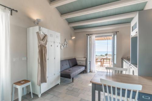 a living room with a couch and a table at Mangiabove in Marina di Ragusa