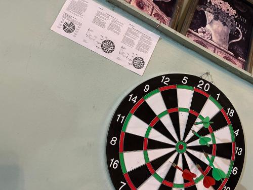 a dart board on a wall with a paper at Tirana Lemon Breeze Hostel in Tirana