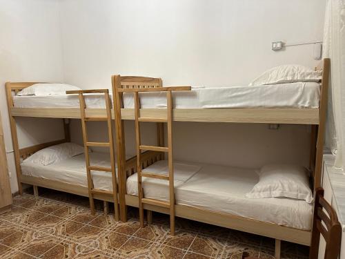 two bunk beds in a small room with at Tirana Lemon Breeze Hostel in Tirana
