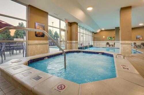 a large pool with a hot tub in a hotel room at Drury Inn & Suites Grand Rapids in Cascade