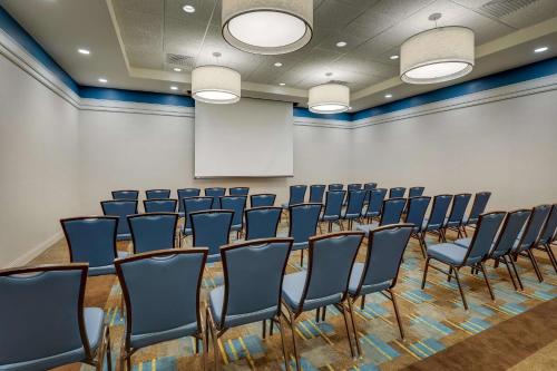 a conference room with chairs and a white wall at Drury Inn & Suites Grand Rapids in Cascade