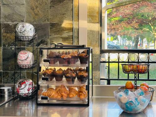 a display of pastries and muffins on a counter at SureStay by Best Western Richmond Vancouver Airport in Richmond