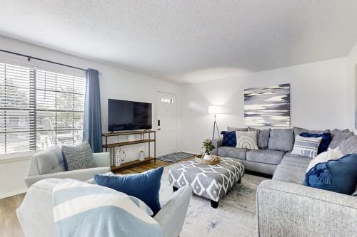 a living room with two couches and a tv at A Touch of Modern in Hot Springs