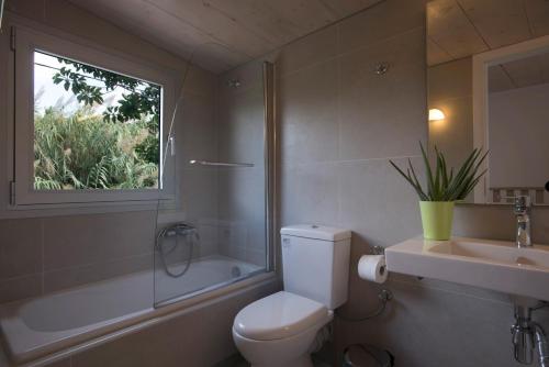 ゲラニ・シャニオンにあるProimos Apartmentsのバスルーム(トイレ、洗面台付)、窓が備わります。