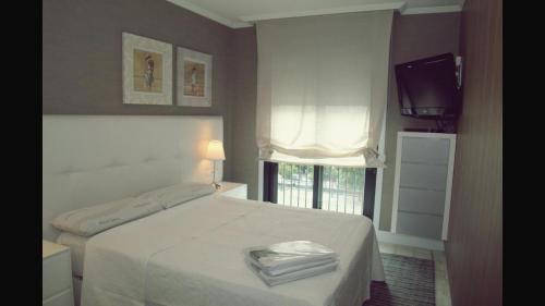 En eller flere senge i et værelse på Piso vacacional carlo