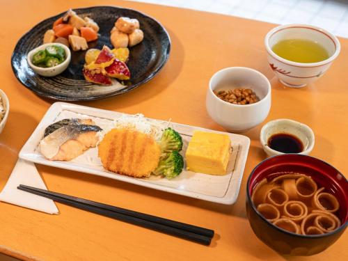 a table with two plates of food and a plate of food at Numazu Grand Hotel in Numazu
