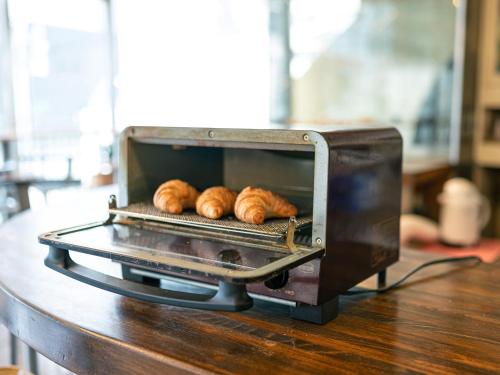 a toaster oven with three loaves of bread in it at Numazu Grand Hotel in Numazu