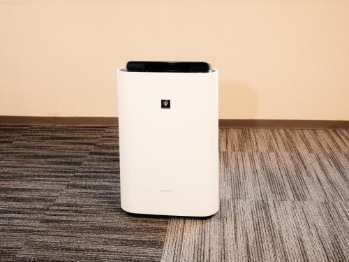 a white refrigerator sitting on the floor at Numazu Grand Hotel in Numazu