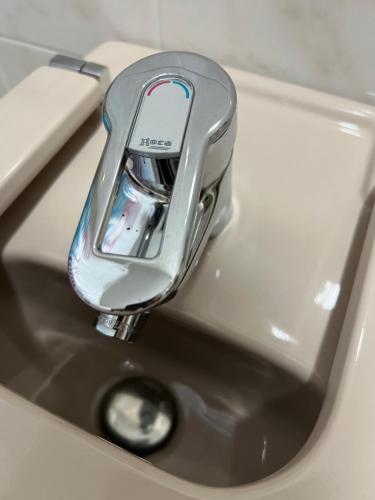 a close up of a faucet on a sink at Ático Calvo Sotelo 217 in Sarria