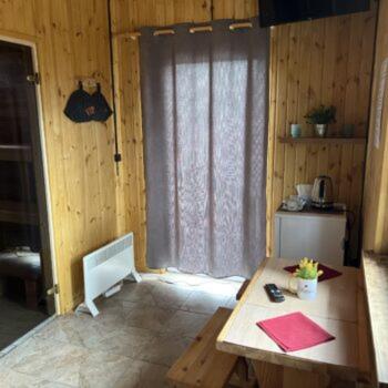 a room with a wooden table and a window at Maja saunaga kahele Arturis in Rõmeda
