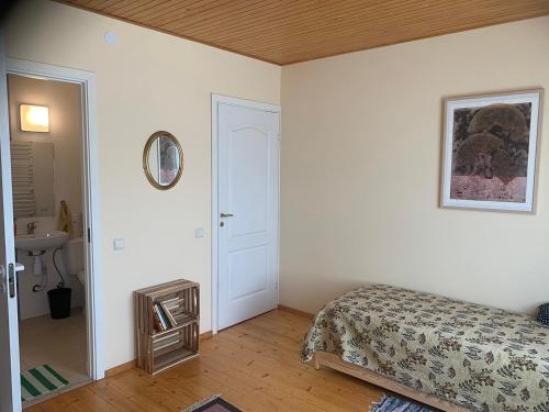 a bedroom with a bed and a sink and a mirror at Artless #2 in Plateliai