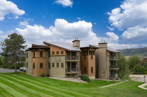a large brick house with a green lawn at Hot Tub, Loft with Balcony, Great Views, 2 Bedrooms, 30 Plus Night Rentals Welcome in Steamboat Springs