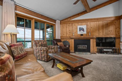 a living room with a couch and a fireplace at Hot Tub, Loft with Balcony, Great Views, 2 Bedrooms, 30 Plus Night Rentals Welcome in Steamboat Springs