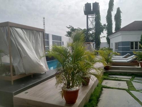 a balcony with potted plants on top of a house at Nene Apartment in Abuja