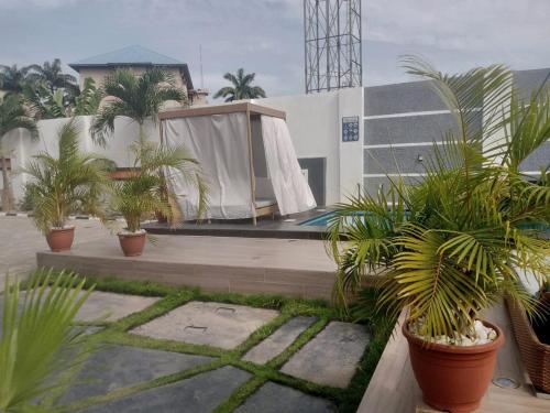 a house with plants in front of a building at Nene Apartment in Abuja