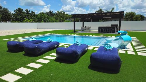 a pool with four inflatablelatable pads around it at Sunny Oasis with private pool in Homestead