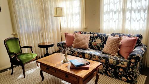 a living room with a couch and a coffee table at Leura House in Leura