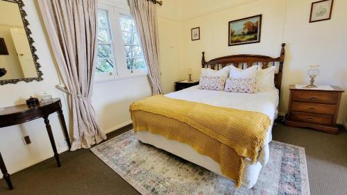 a bedroom with a bed and a window at Leura House in Leura