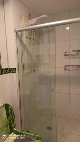 a shower with a glass door in a bathroom at Apartment Neo 2.0 in Maceió