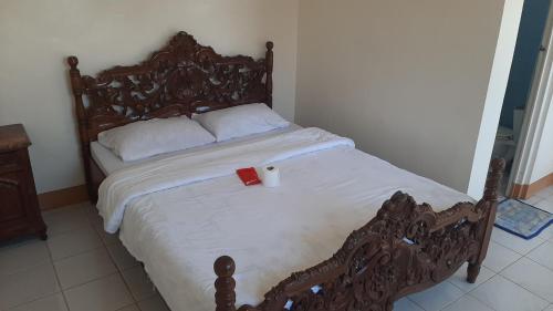 a bed with a cup on top of it at White Castle Beach Resort in Iba