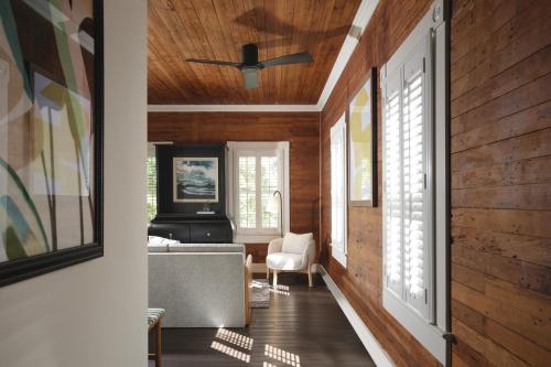 a living room with wood paneling and a ceiling at Ridley House - Key West Historic Inns in Key West
