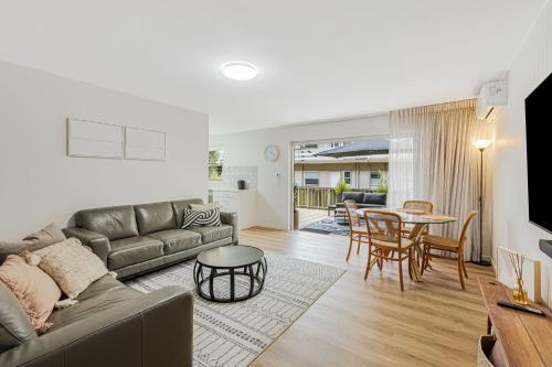 a living room with a couch and a table at 3 Haig Place in Gold Coast