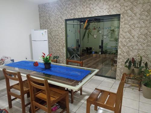 a dining room with a blue table and chairs at Casa para 12 pessoas perto da Basílica e da Feira in Aparecida