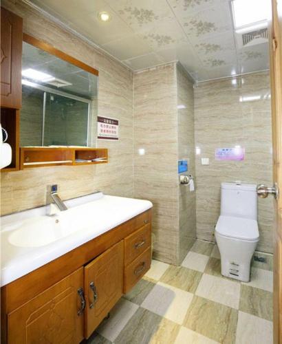 a bathroom with a sink and a toilet at Longji Panorama Hotel 龙脊全景楼大酒店 in Longsheng
