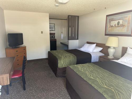 a hotel room with two beds and a television at JET Motor Inn in Powell
