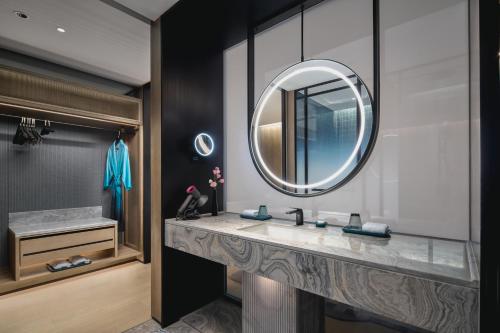 a bathroom with a sink and a mirror at Hotel Indigo Suzhou Jinji Lake by IHG in Suzhou