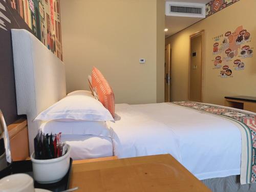 a bedroom with a white bed and a table at Baiyun Hotel Guangzhou in Guangzhou