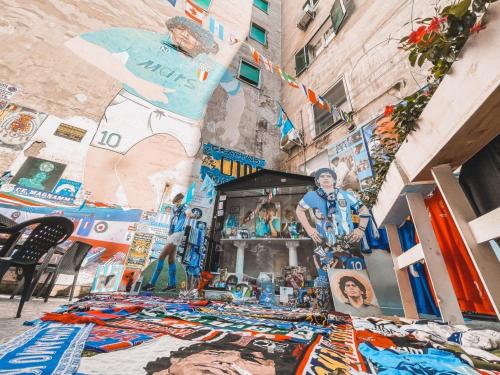 a street with a lot of pictures on the side of a building at A Ninnella Casa Vacanze in Naples