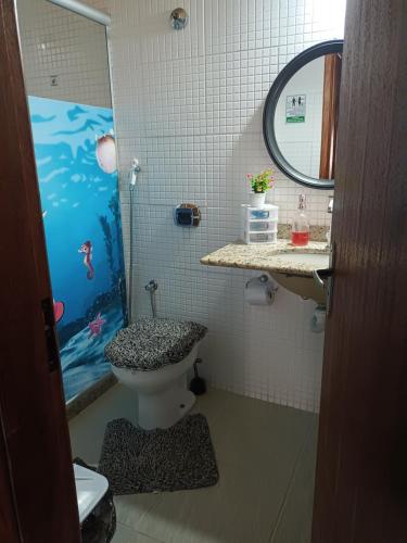 a bathroom with a shower and a toilet and a sink at Mandalas Guest House in Cabo Frio