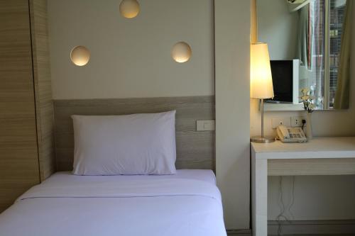 Ένα ή περισσότερα κρεβάτια σε δωμάτιο στο Sunshine Hotel & Residences
