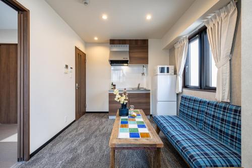 a living room with a couch and a table at AI Annex in Osaka