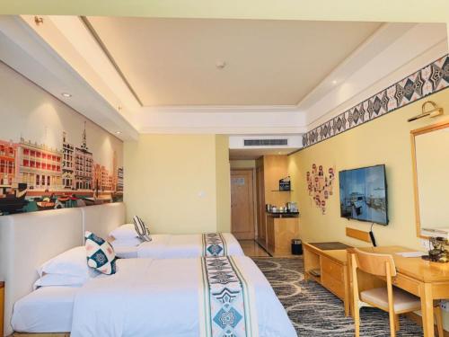 a hotel room with two beds and a desk at Baiyun Hotel Guangzhou in Guangzhou