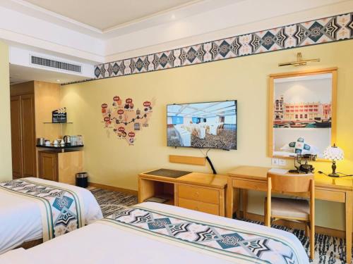 a hotel room with two beds and a desk at Baiyun Hotel Guangzhou in Guangzhou