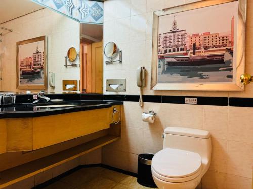 a bathroom with a toilet and a sink at Baiyun Hotel Guangzhou in Guangzhou