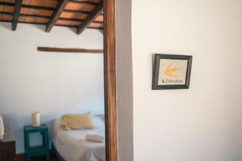 a mirror in a room with a bed at Loma Puskana - Hostería in Cachí