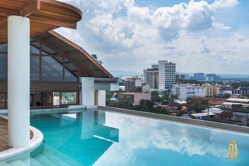 a swimming pool with a view of a city at Azzurro Hotel in Angeles