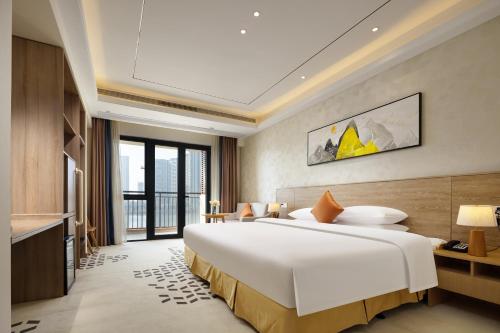 Ένα ή περισσότερα κρεβάτια σε δωμάτιο στο Q-Box Ningbo Hangzhou Bay
