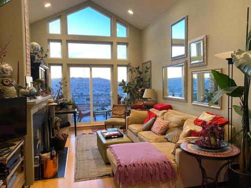 a living room with a couch and a large window at San Francisco Potrero Hill Nest in San Francisco