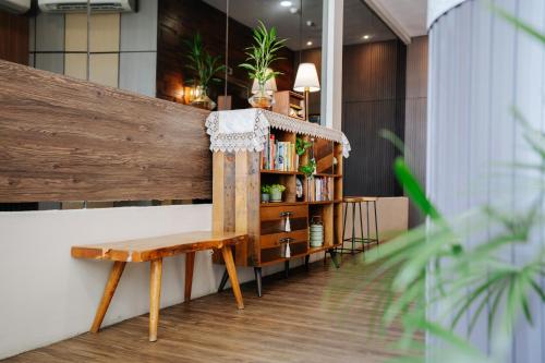 a wooden bench in a room with a book shelf at Wangs Hotel Gurney Drive in George Town