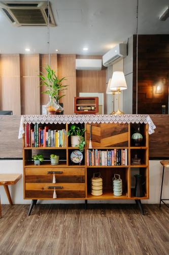 a book shelf with books and plants on it at Wangs Hotel Gurney Drive in George Town