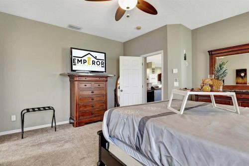 a bedroom with a bed and a dresser at Golf Course Community! Amazing Home for 8 Guests in Valrico